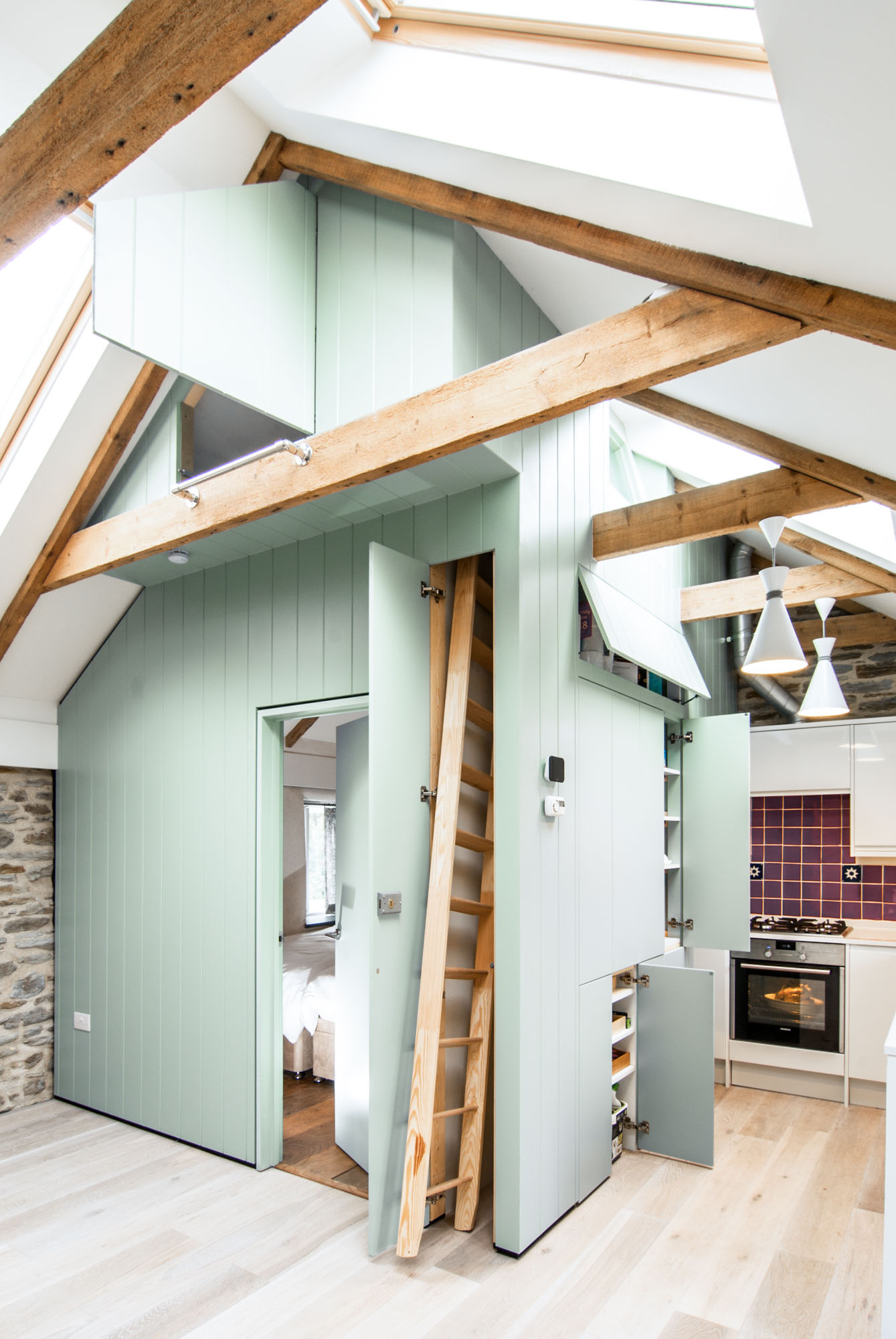 Exposed beams and hidden ladder within the concealed room structure.
