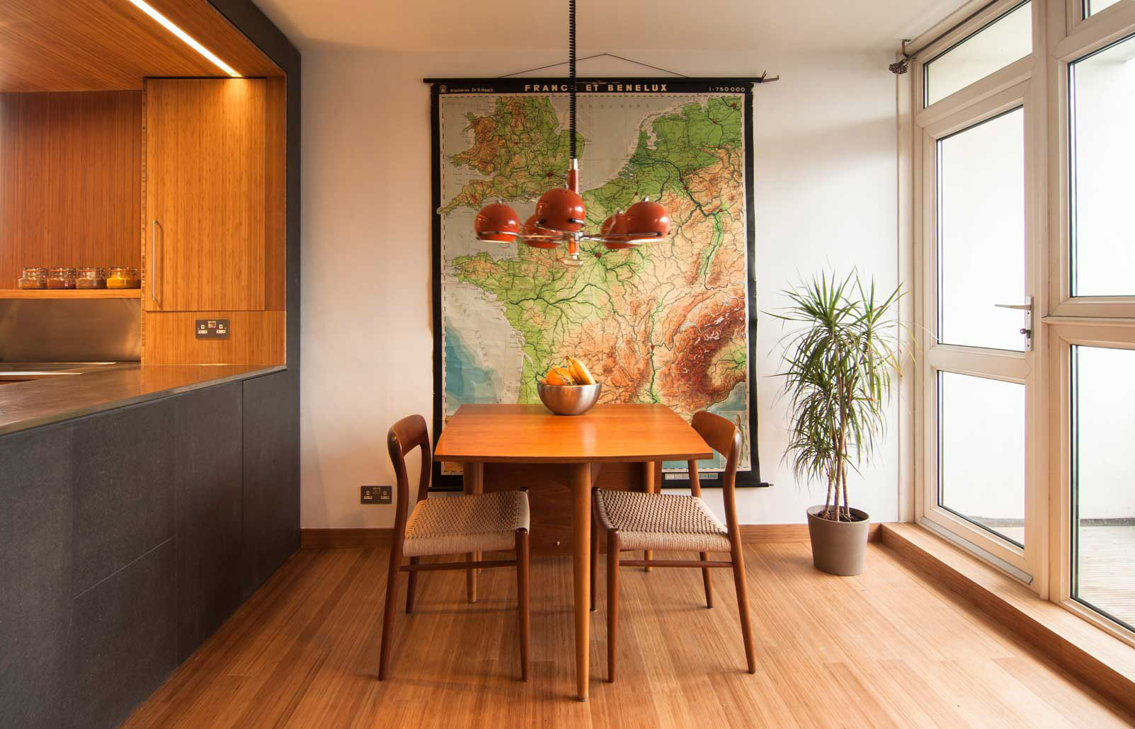 View of dining table with map of europe on wall