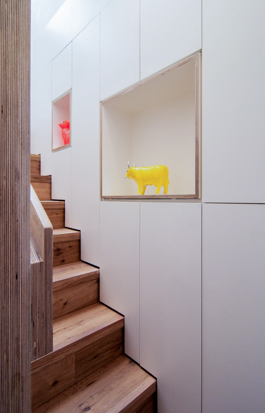 Bespoke staircase and contemporary storage and shelving providing plenty of storage space.