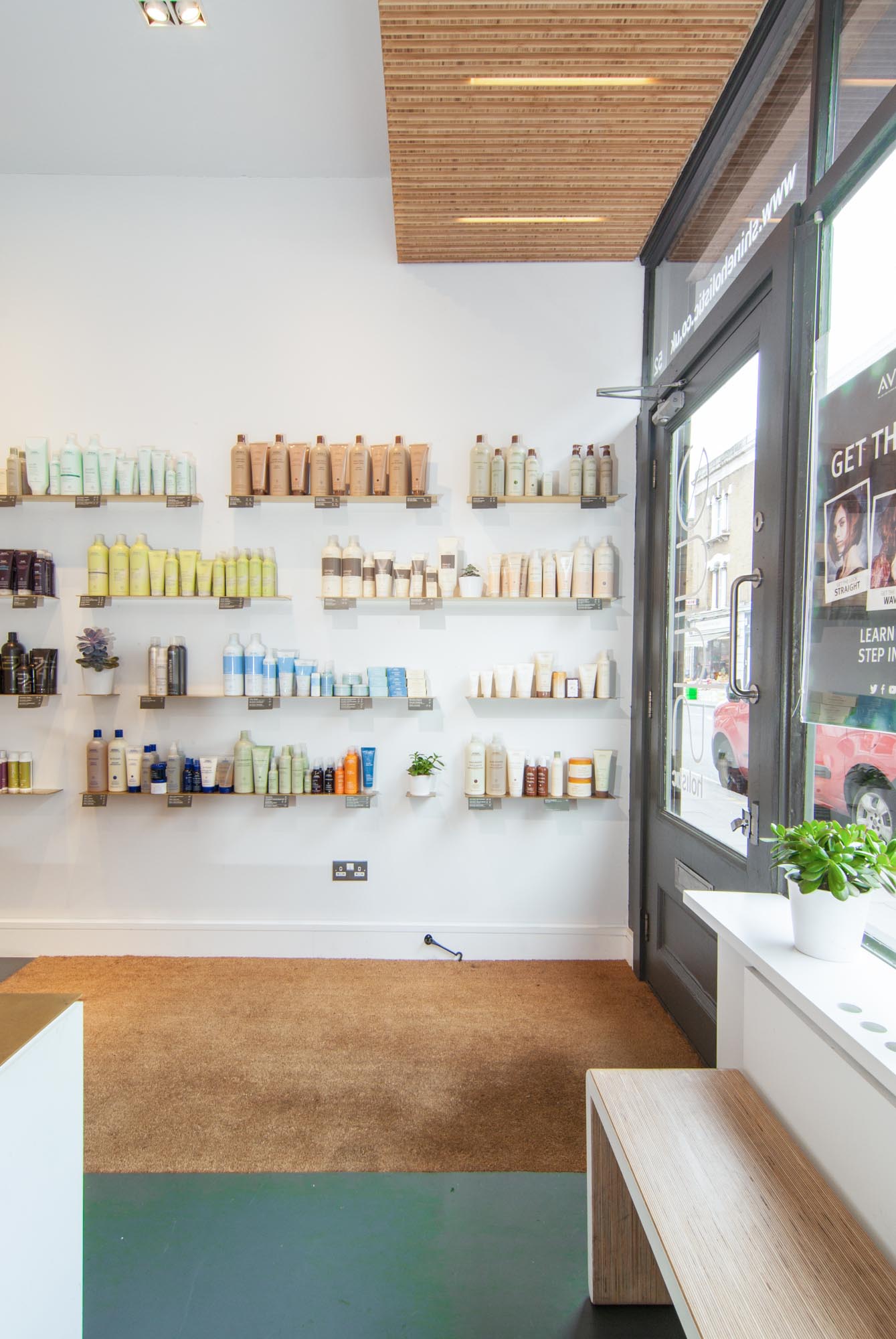 Brass shelving by the entrance of Shine Holistic Hairdresser salon.