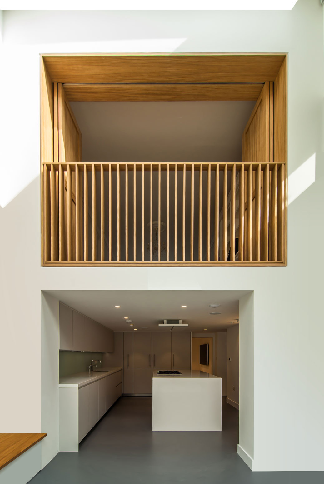 Internal balcony consisting of an Oak shutter frame balustrade being the focus amongst the white walls.