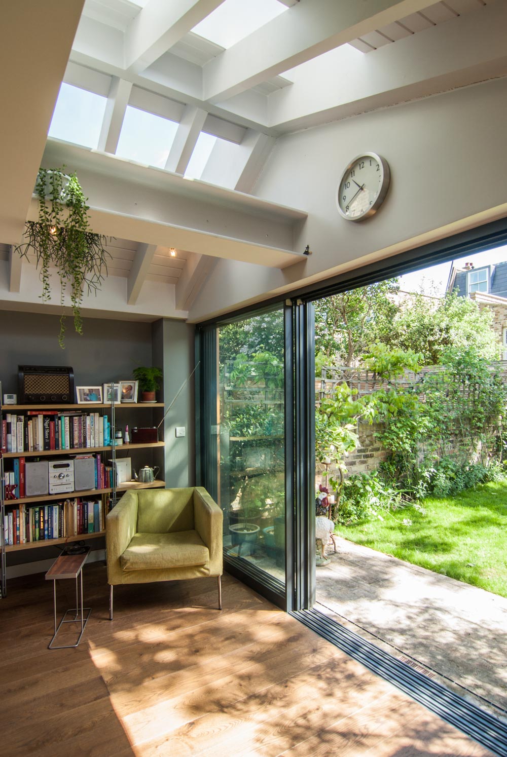 Roof lights overlooking a peaceful reading corner next to the scenic garden view.