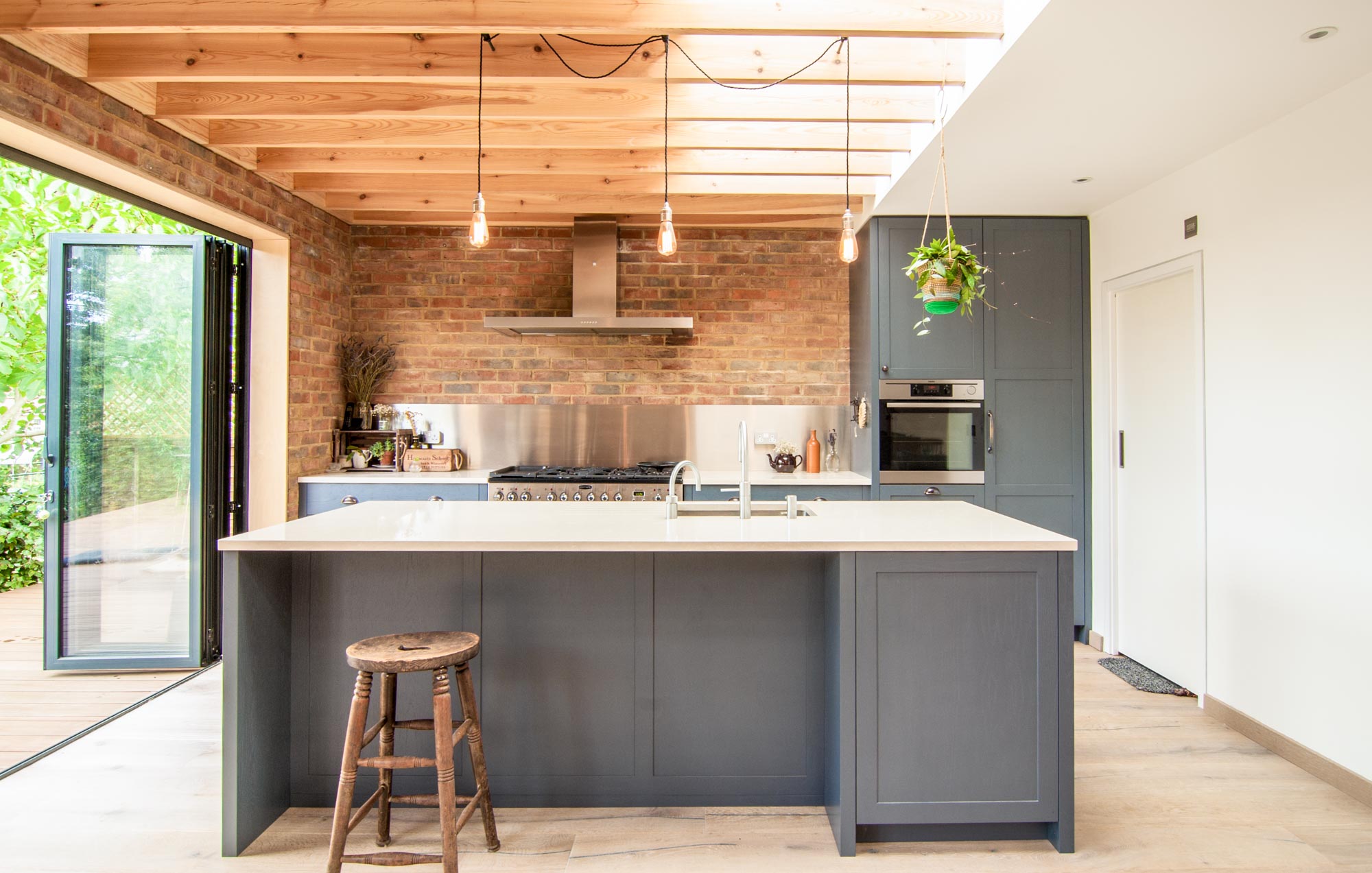Exposed brick walls and timber beams in the new kitchen extension.