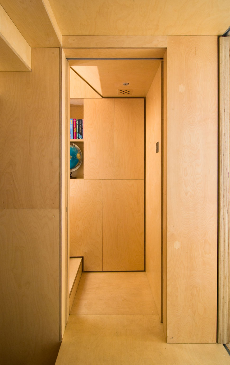 Plywood hidden storage units in the corridor of the Mews Property.