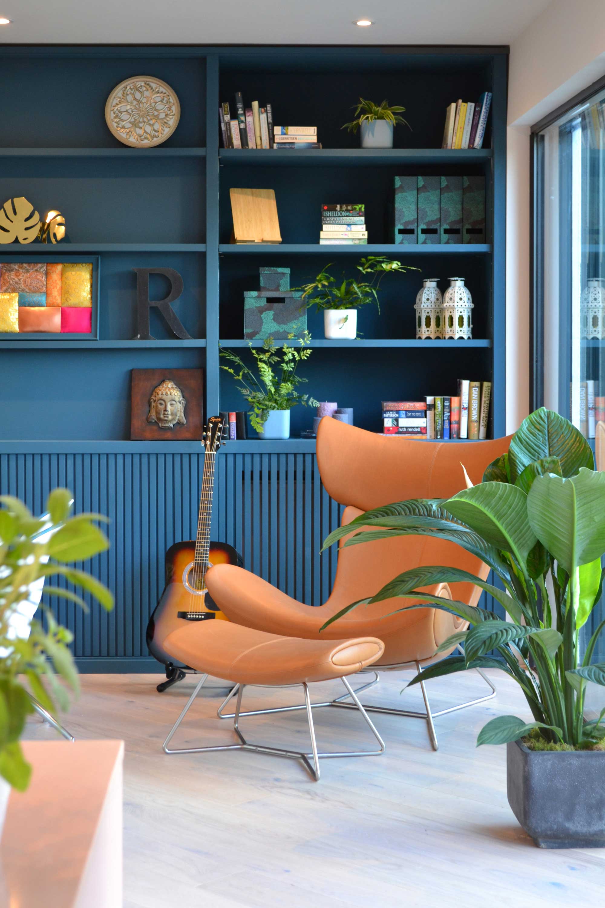 Love Your Home and Garden- Beautiful teal bookshelf and a coloured leather arm chair forming the perfect reading corner.