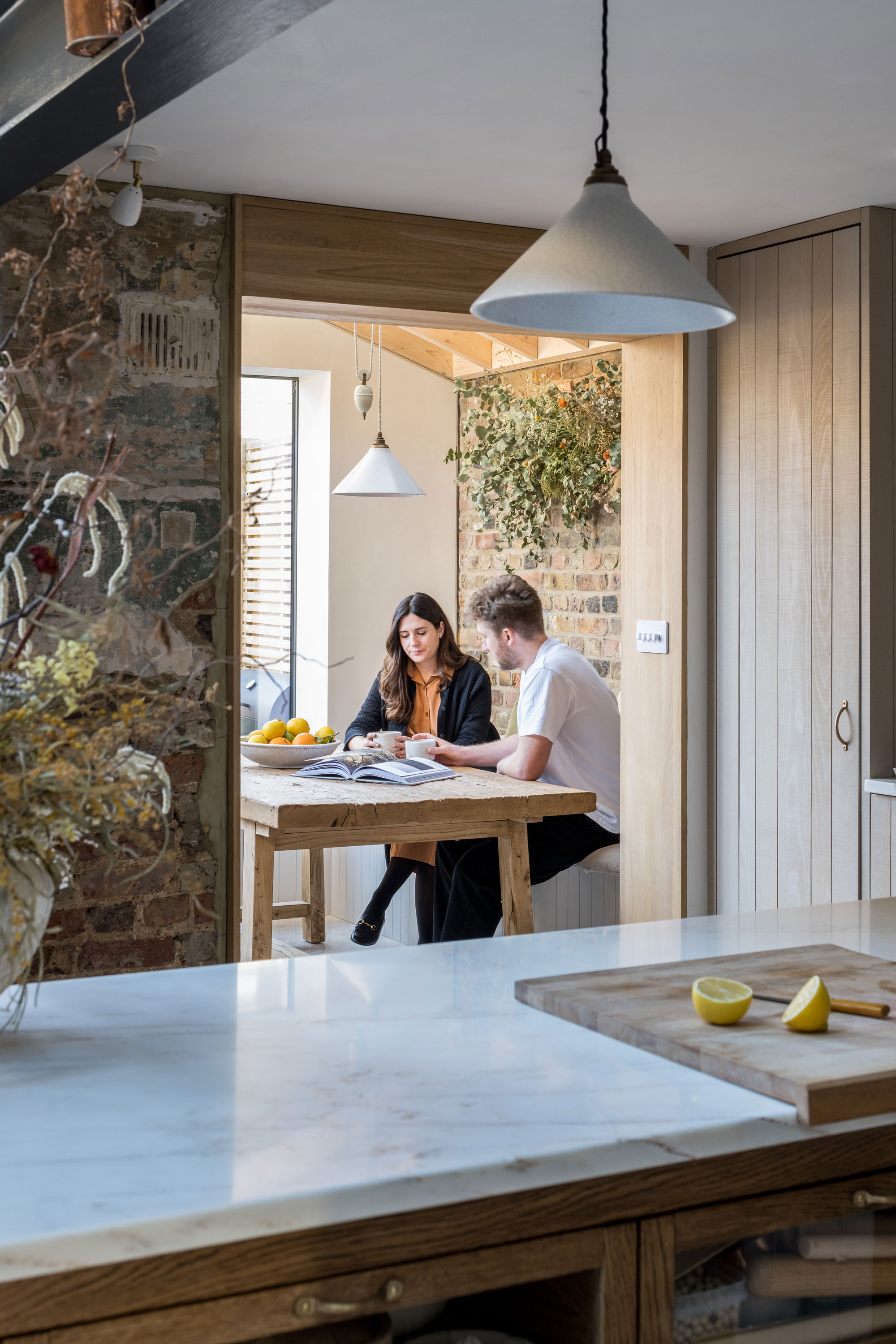 Martina and Joe sat at a table in their home