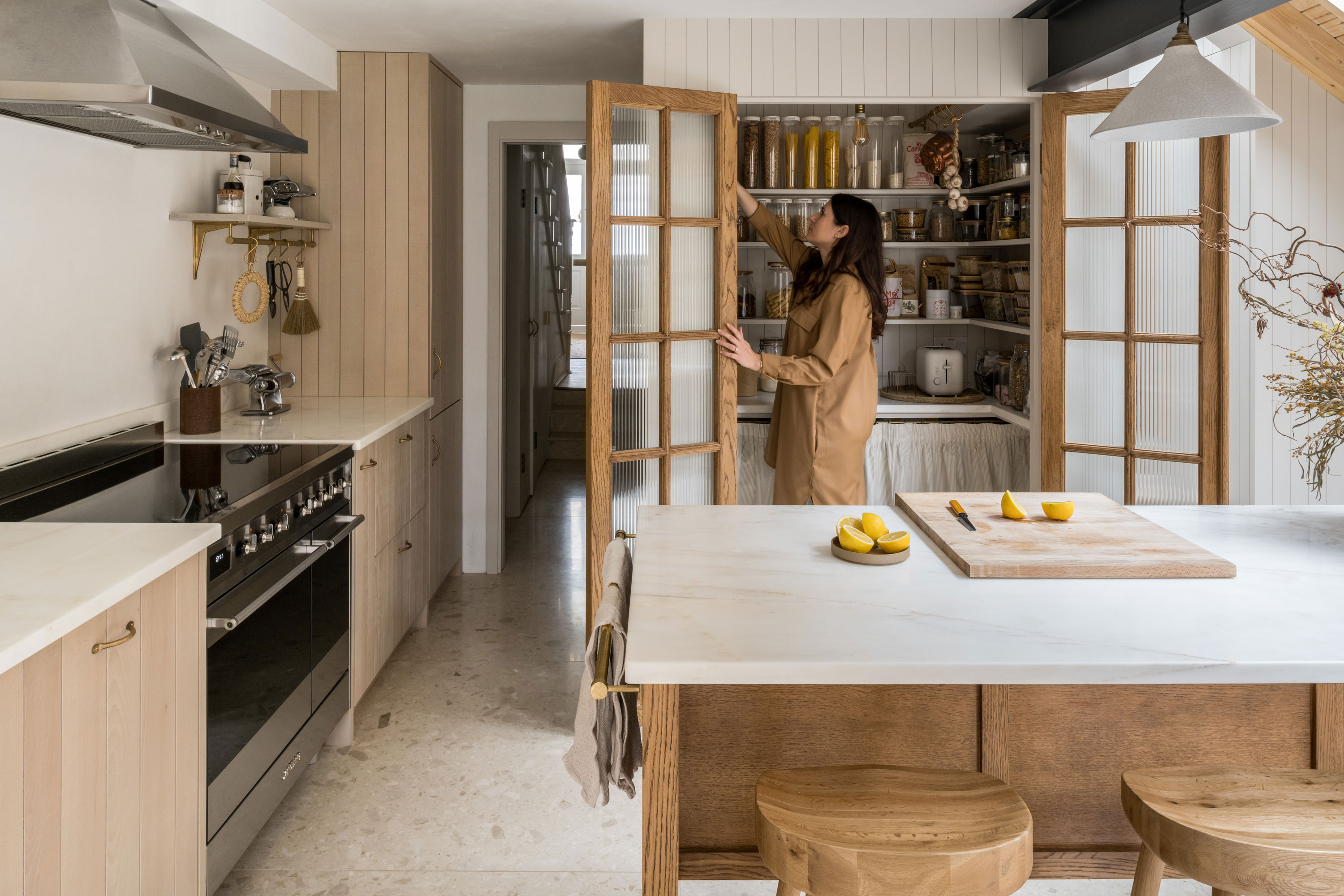 Martina in the kitchen looking through her kitchen storage