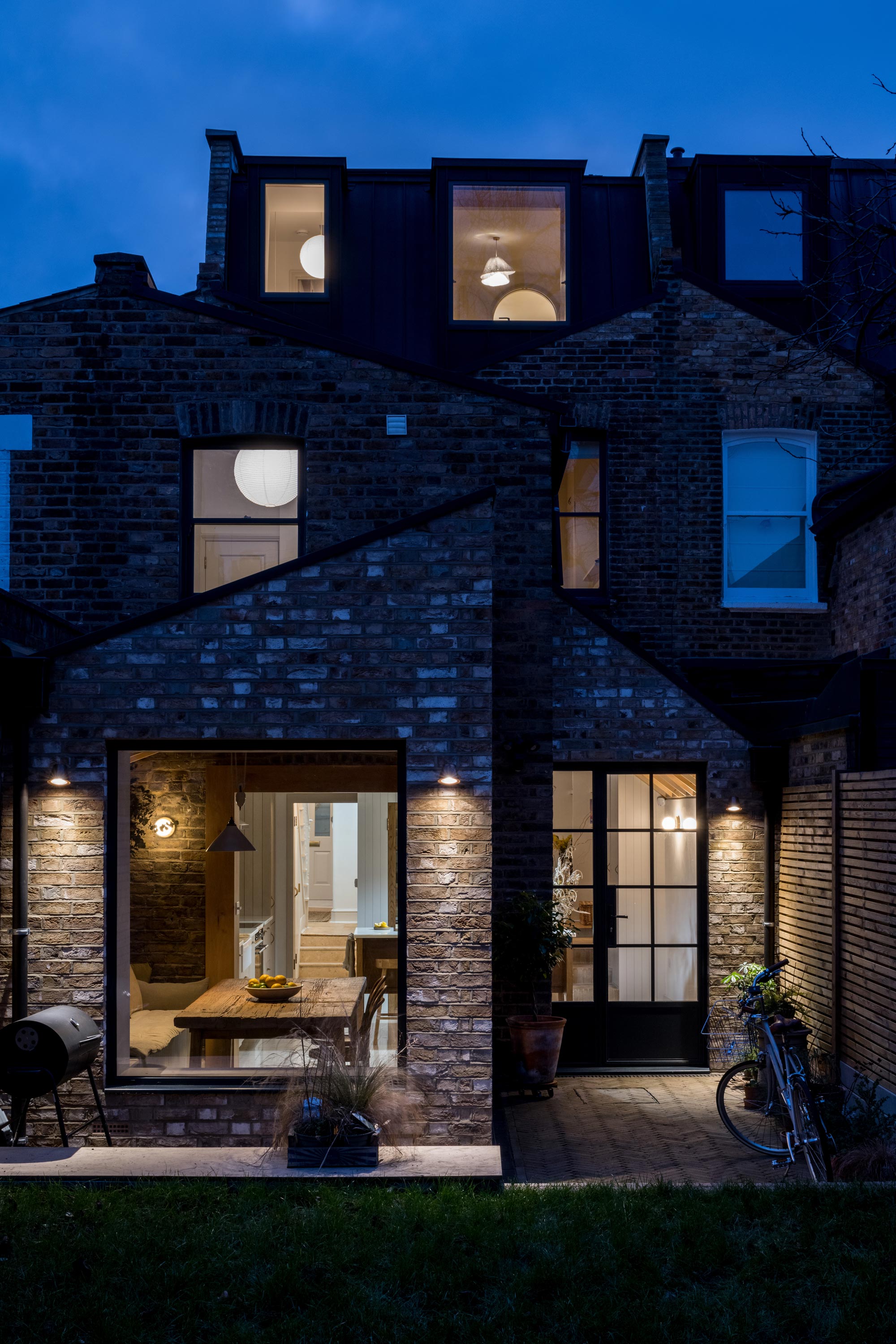 REAR VIEW GARDEN EVENING NIGHT SHOT GARDEN LIGHTS PATIO VERTICAL