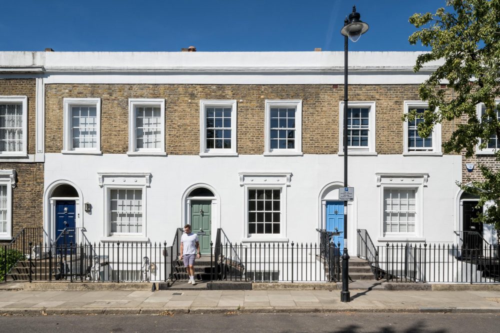 Front façade of a listed period home in Islington with white stucco, classic proportions, and traditional detailing.