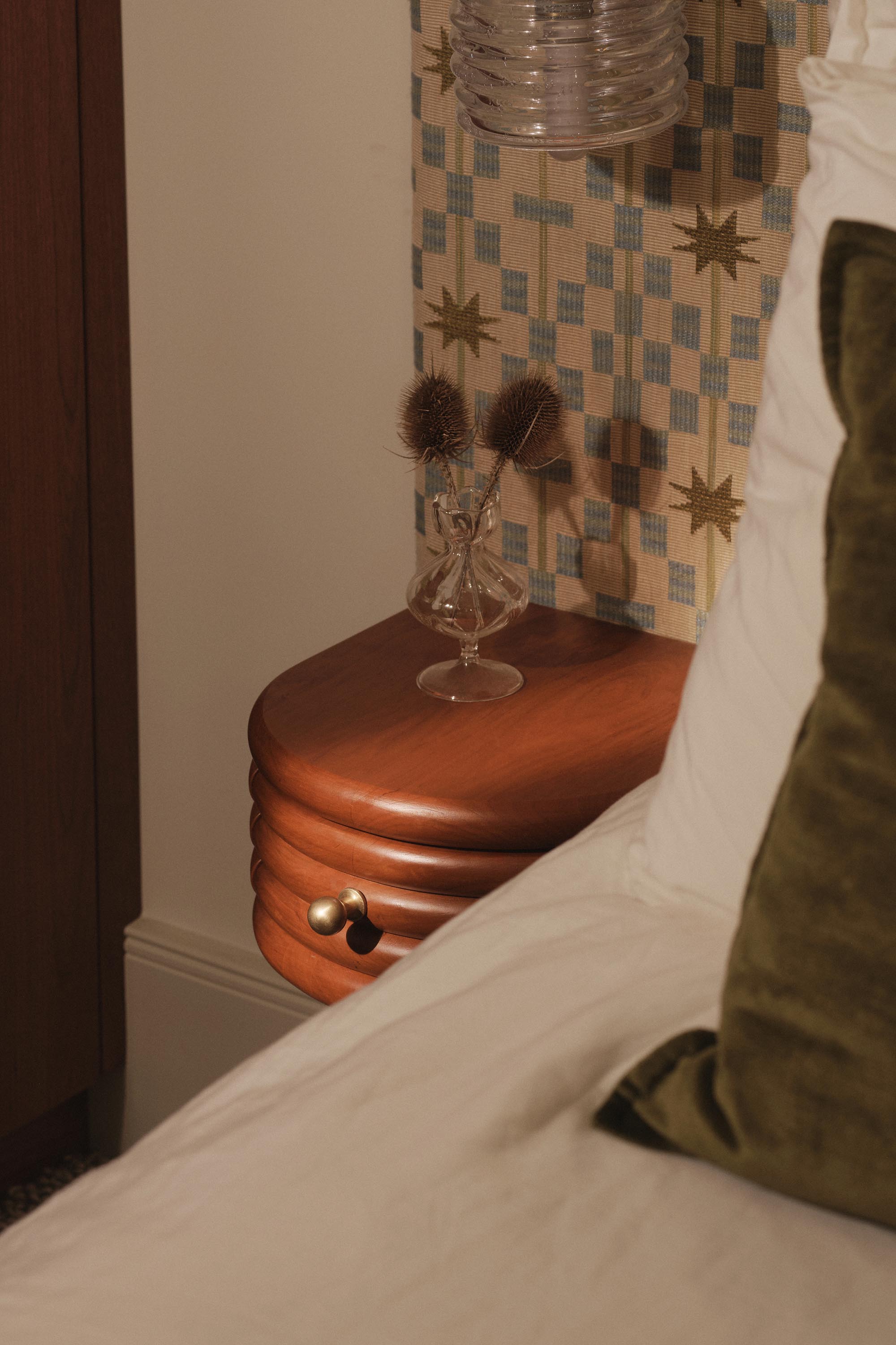 Lauriston bedroom with cherry red stained oak bed and mid-century bedside table