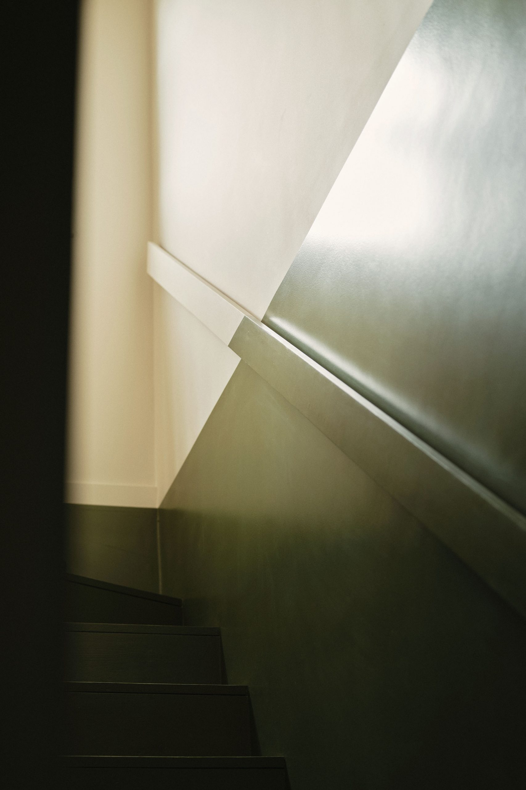 Lauriston hallway and staircase with green monochrome two-tone design, minimal handrail, and balustrade