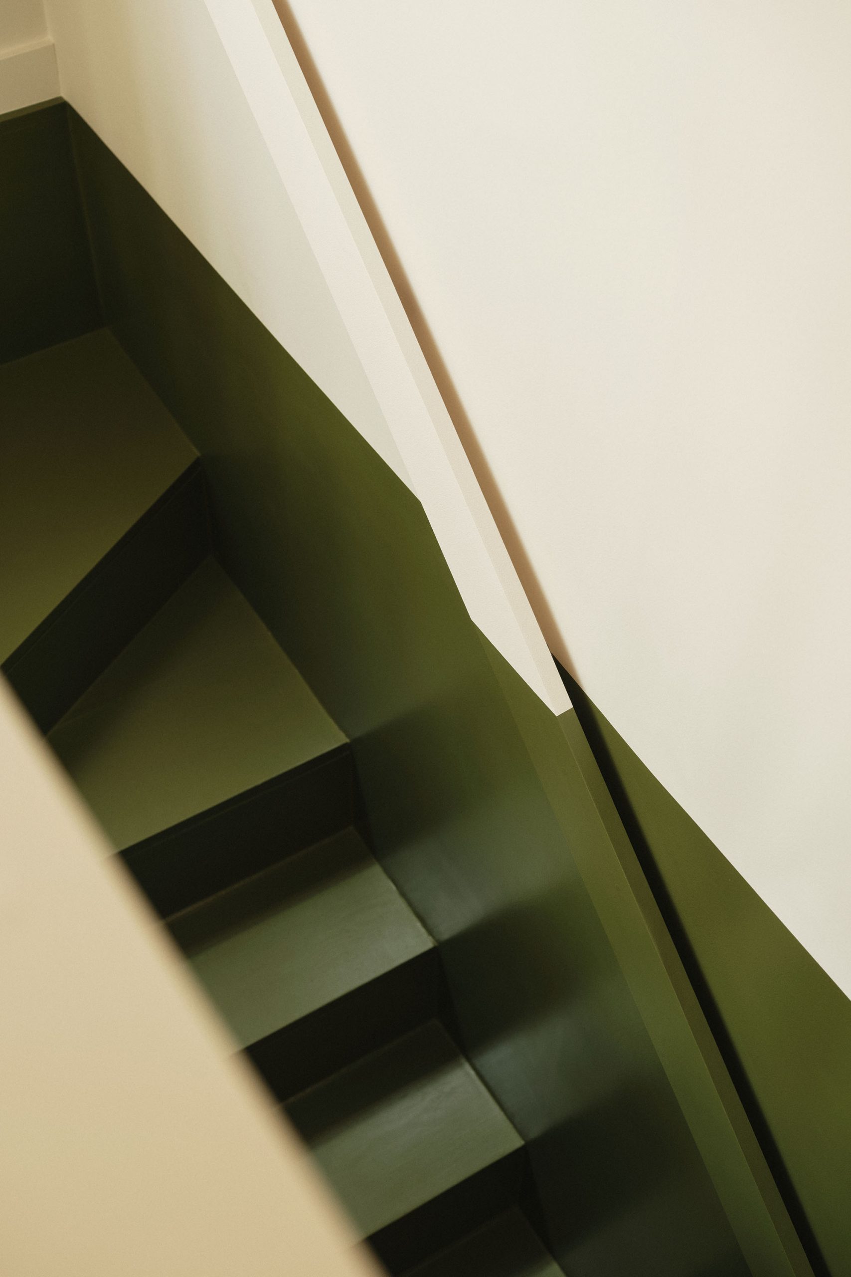Lauriston hallway and staircase with green monochrome two-tone design, minimal handrail, and balustrade, viewed from above