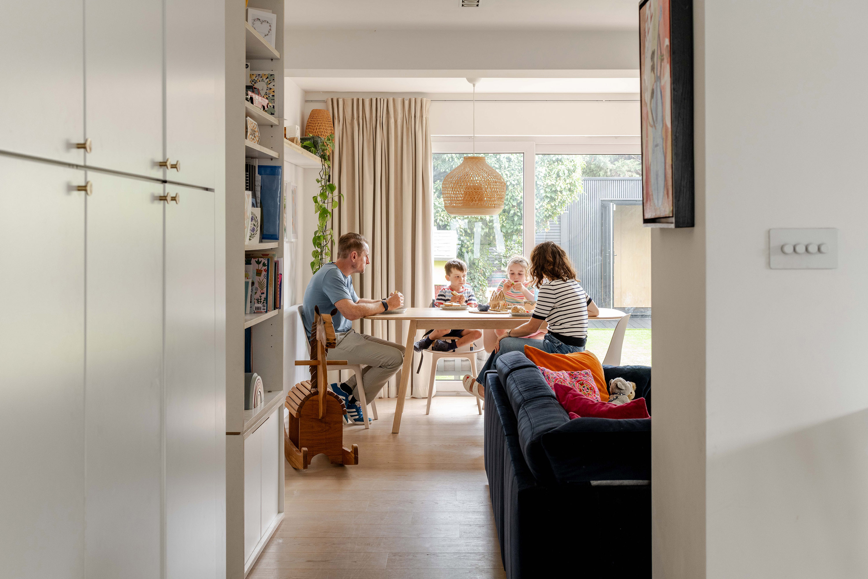 Dining table positioned adjacent to the garden with daylight and views outside.