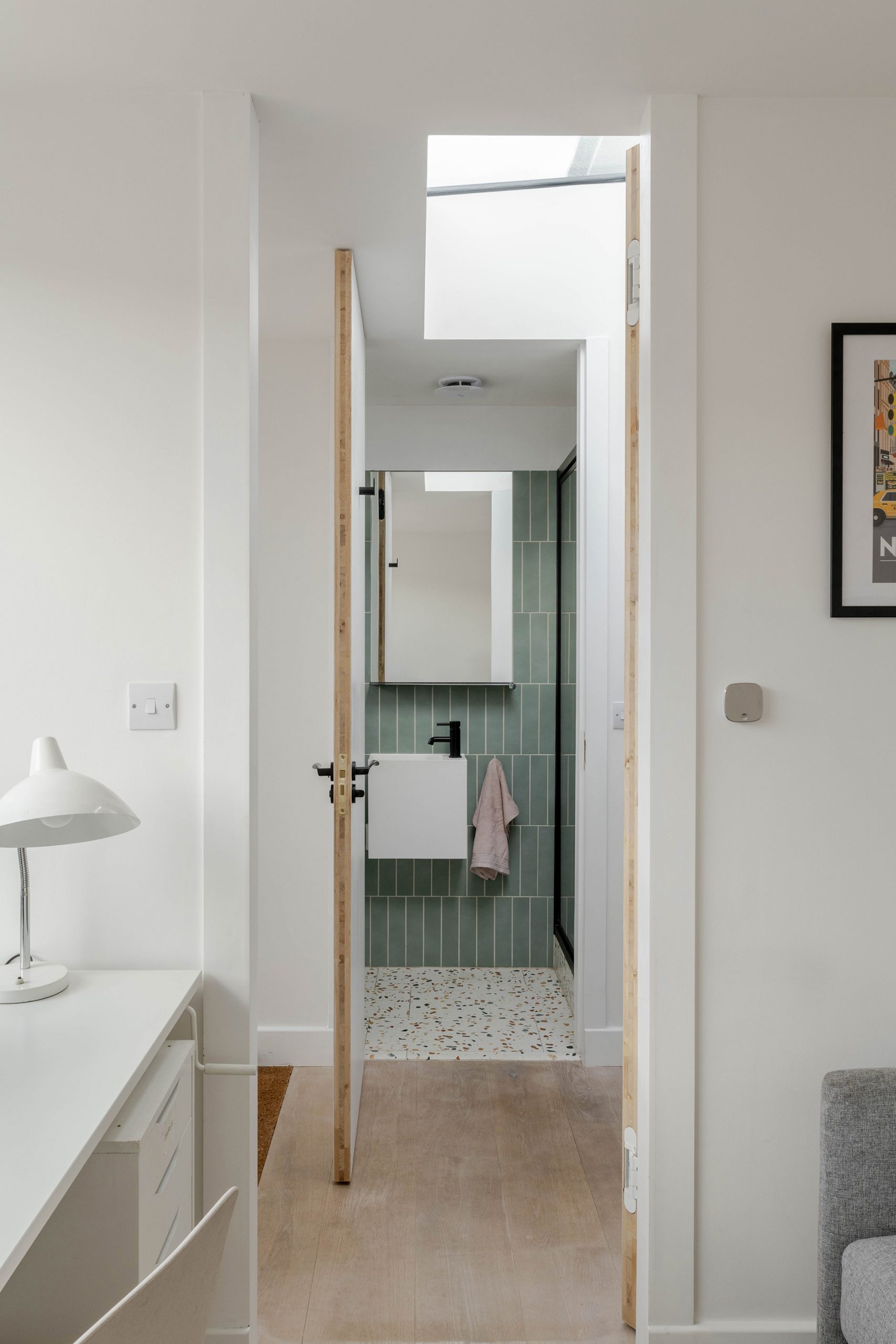 Downstairs toilet and shower room off front entrance with floor to ceiling doors.