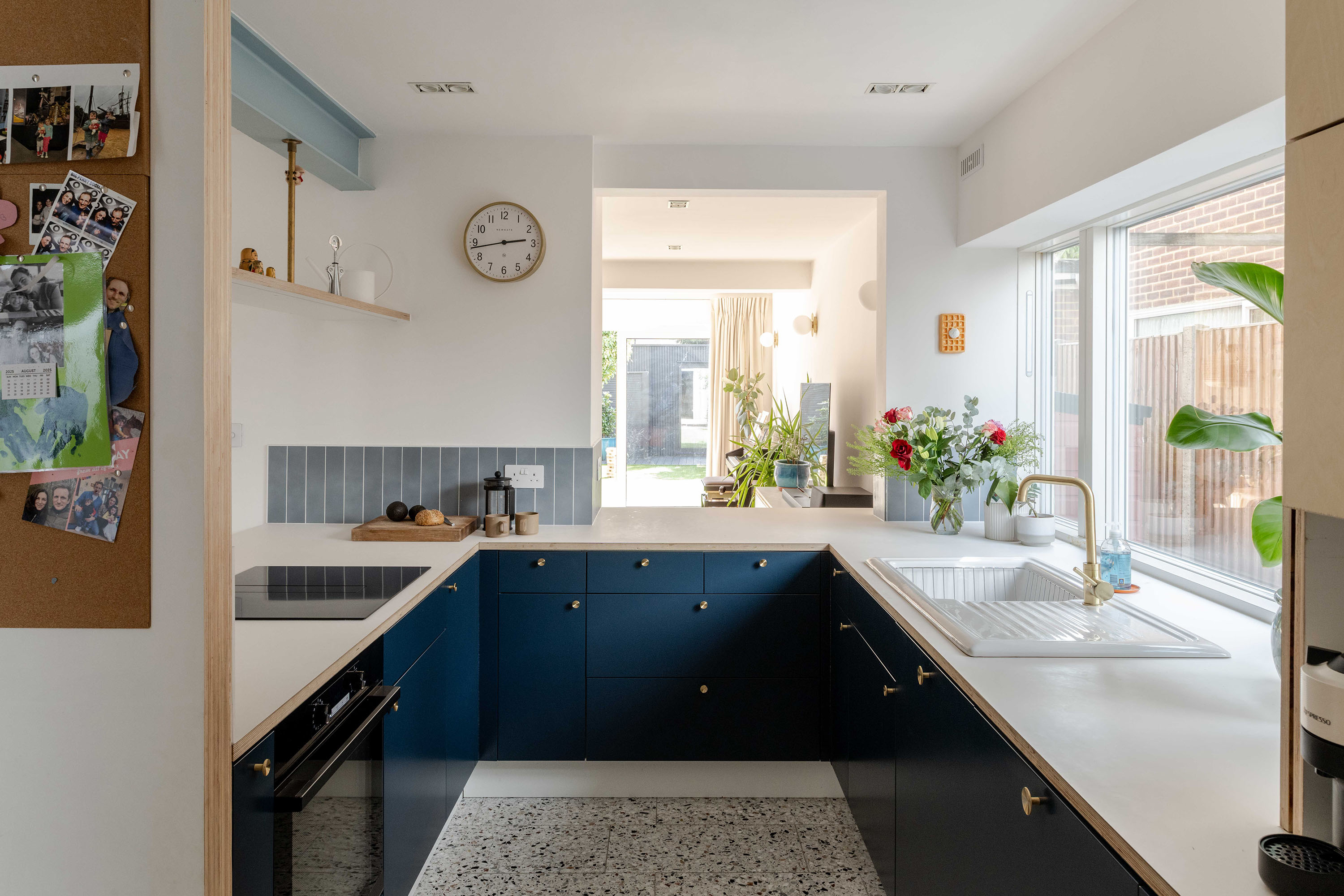 U-shaped kitchen with ceramic waffle artwork on the wall as a focal detail.