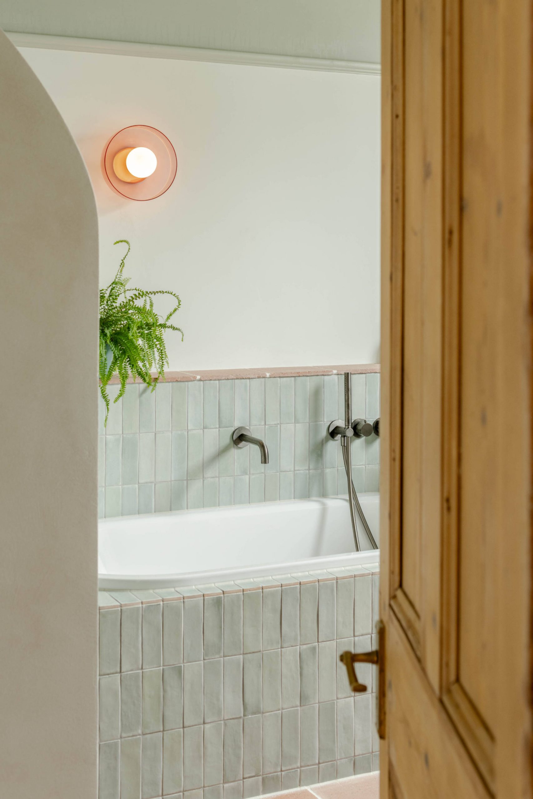 Modern bathroom with warm material palette in a London residential renovation designed by Bradley Van Der Straeten Architects.