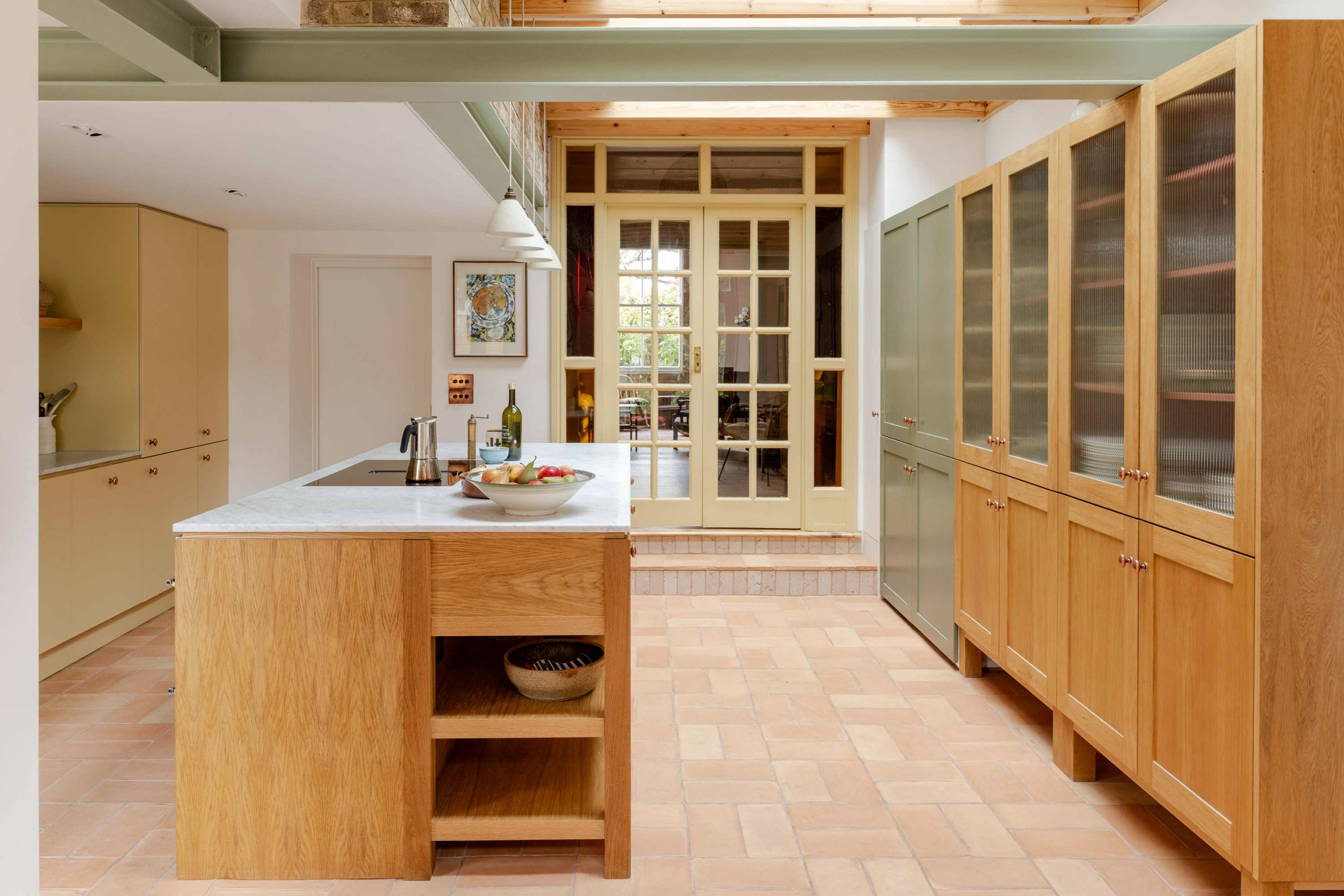 Open plan kitchen designed for family gatherings in a Stoke Newington terrace renovation by Bradley Van Der Straeten Architects.