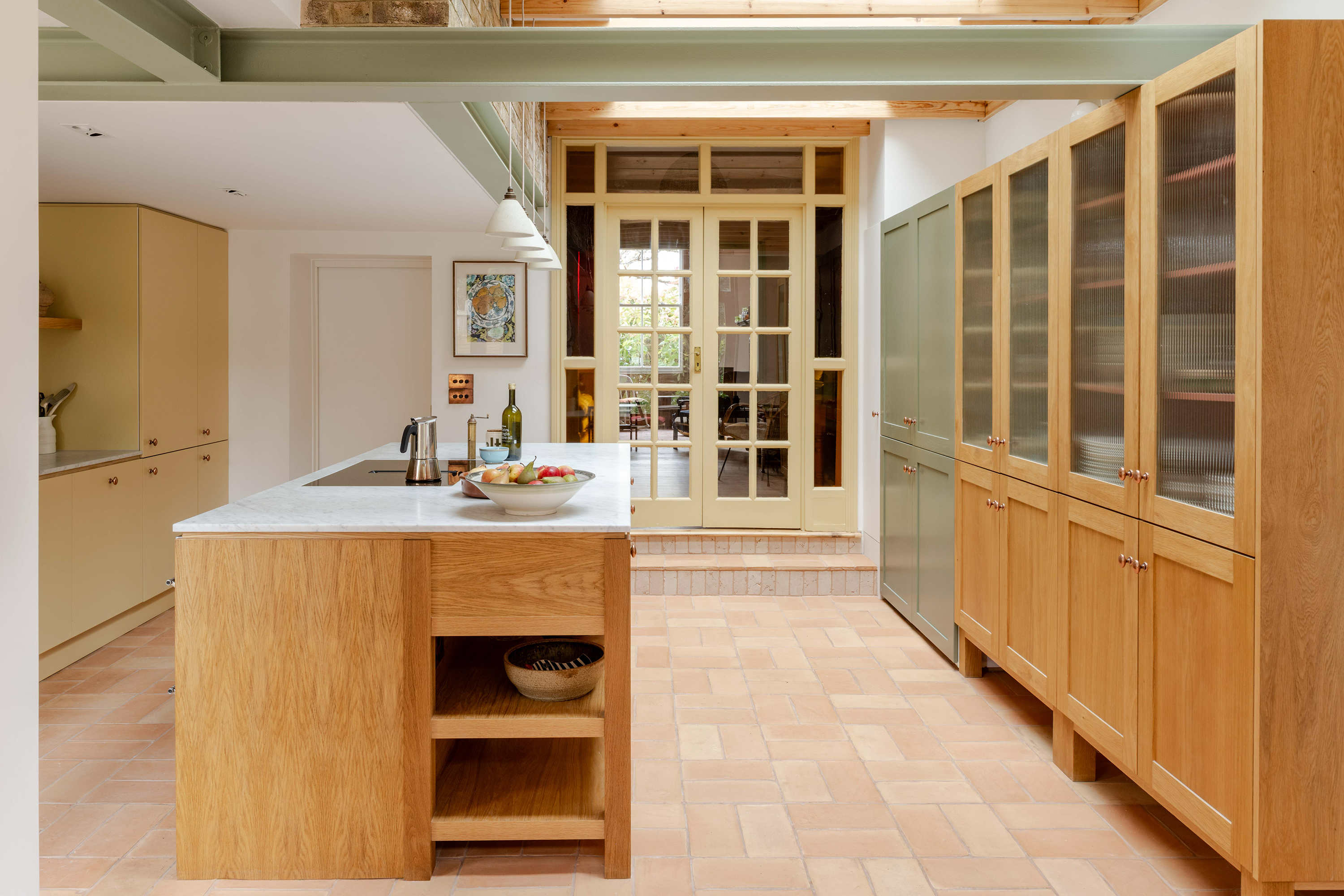 Open plan kitchen designed for family gatherings in a Stoke Newington terrace renovation by Bradley Van Der Straeten Architects.