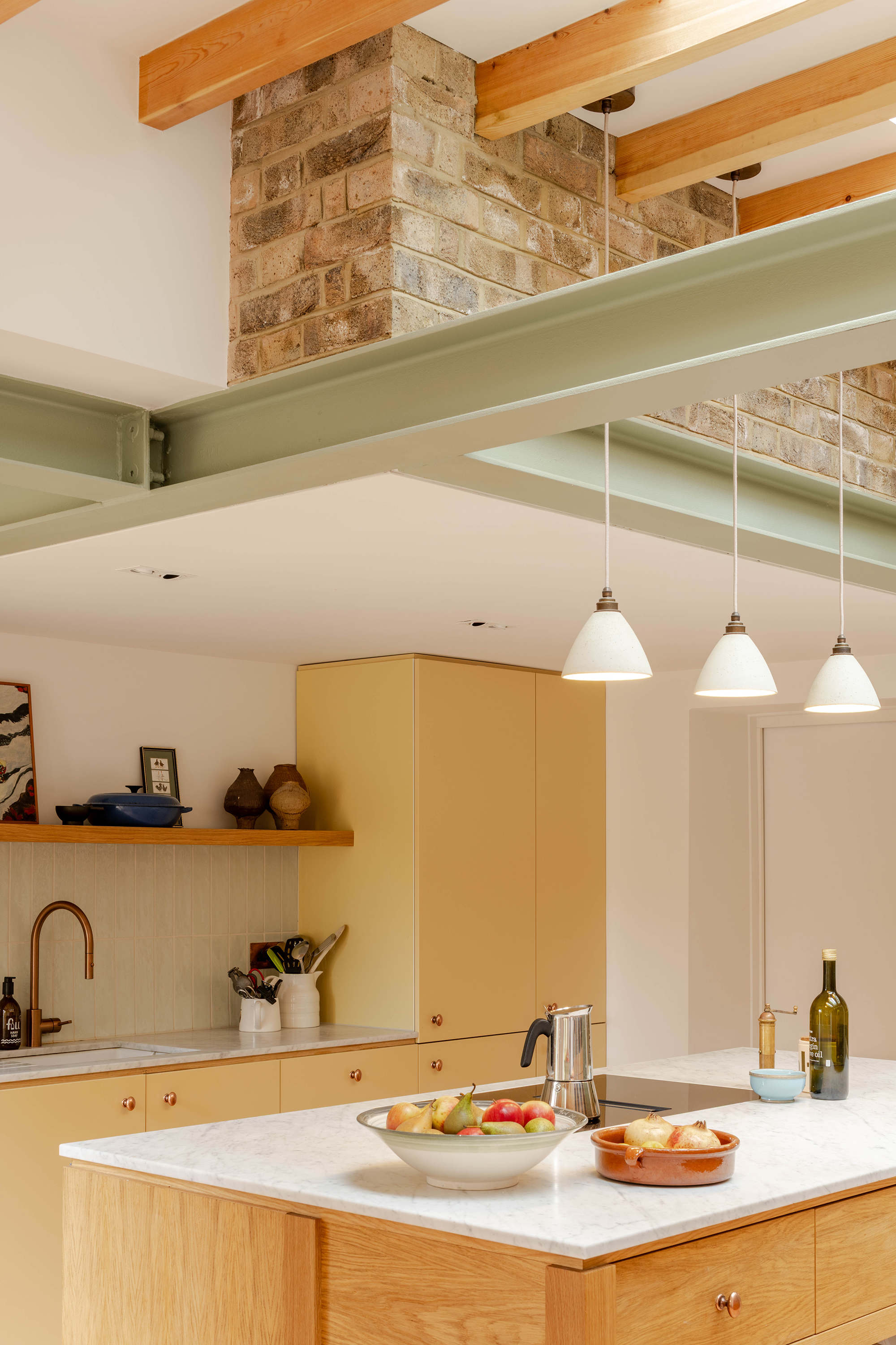 Kitchen island and open plan dining space in a London terrace extension designed by Bradley Van Der Straeten Architects.