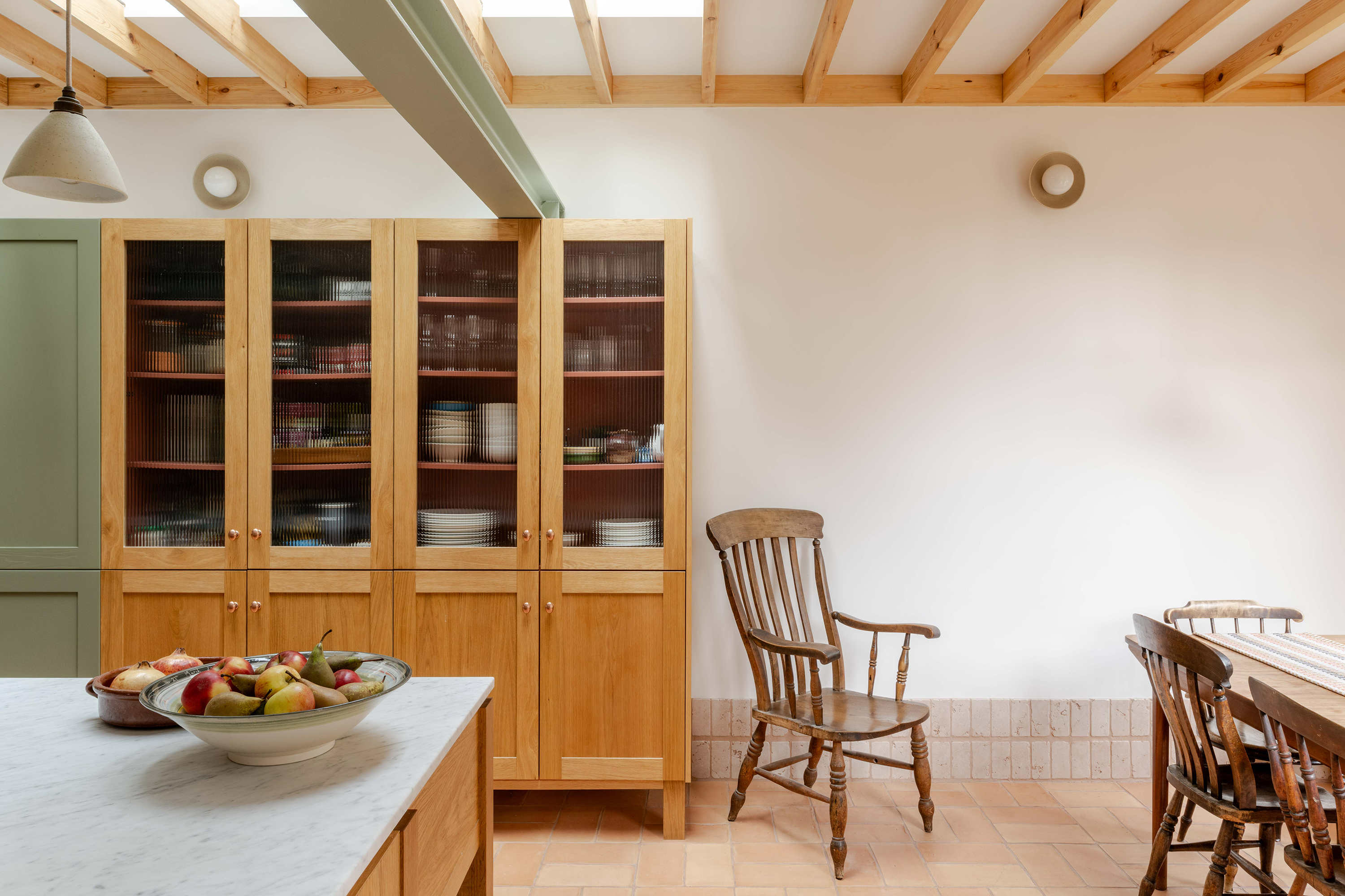 Open plan kitchen in a Stoke Newington rear extension designed by Bradley Van Der Straeten Architects with terracotta flooring and bespoke timber joinery.