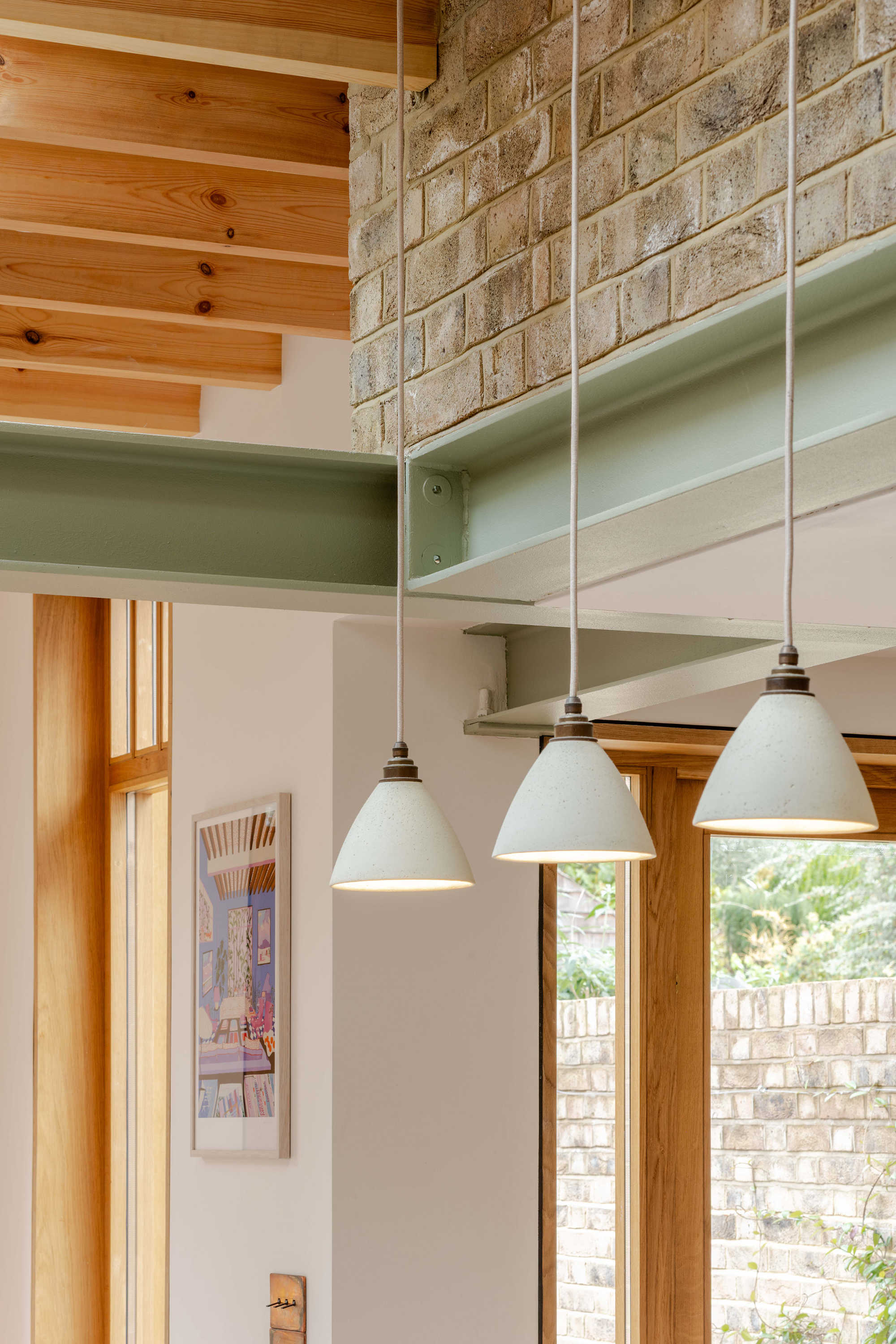 Exposed steel beams within a Stoke Newington kitchen extension designed by Bradley Van Der Straeten Architects.