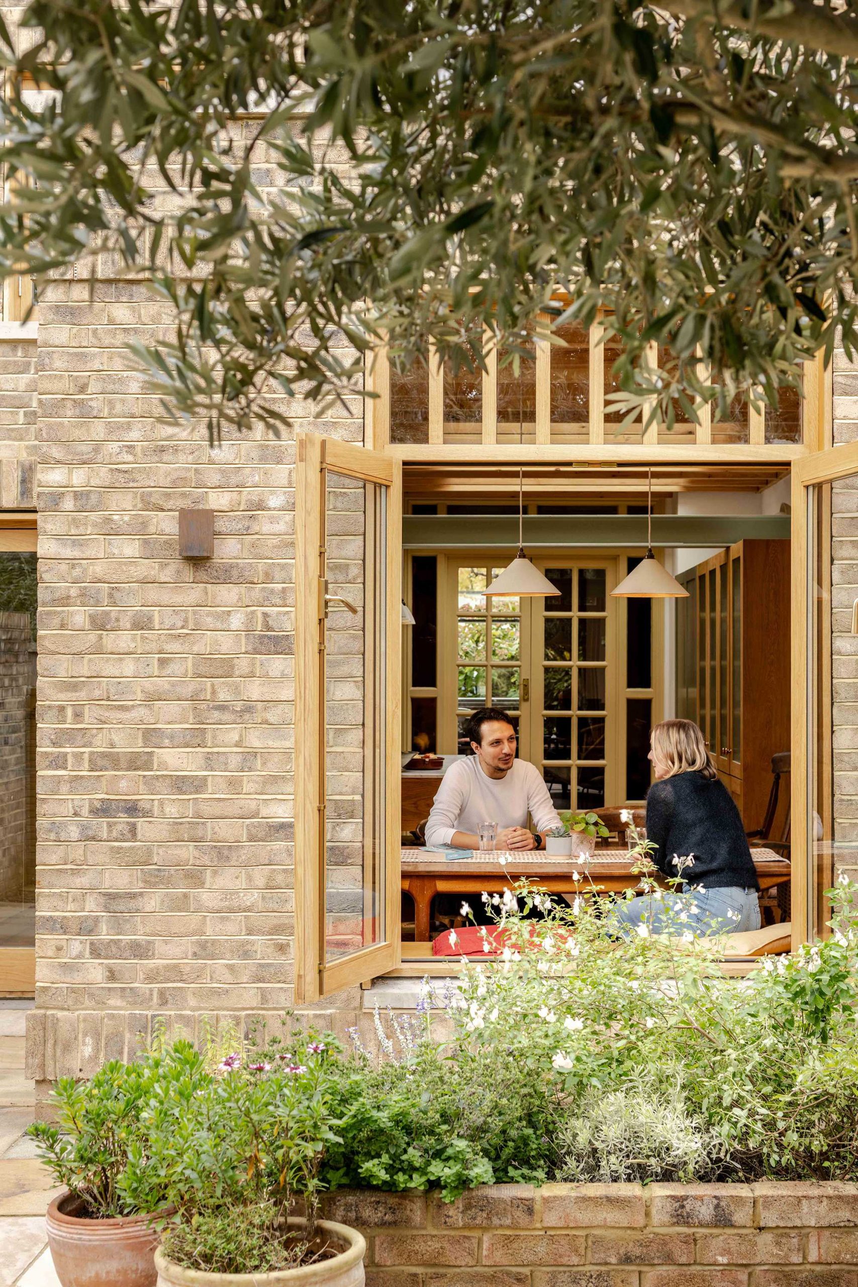 Contemporary rear addition to a Victorian terrace in North London by Bradley Van Der Straeten Architects with reclaimed brick and timber joinery.