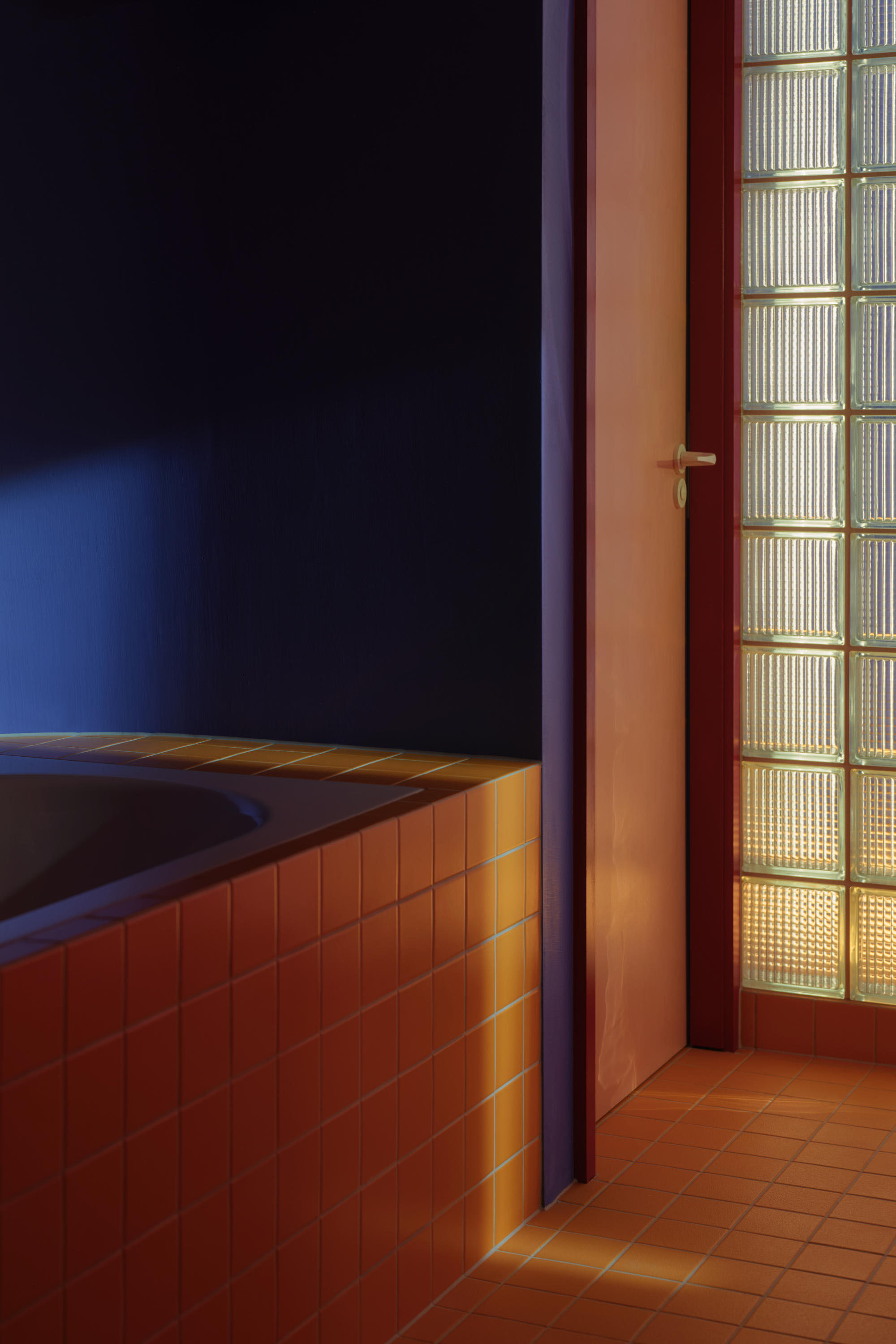 Bathroom extension with terracotta tile walls and glass block window creating bright, open plan living space.