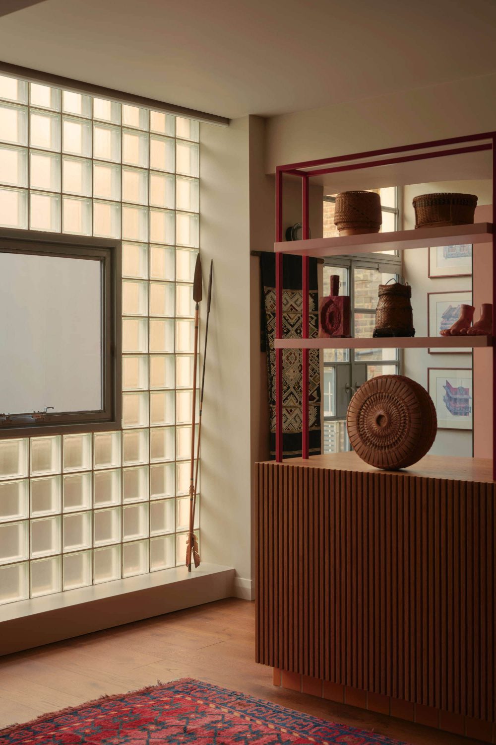 Modern kitchen extension with glazed brick wall and open plan living space featuring timber shelving.