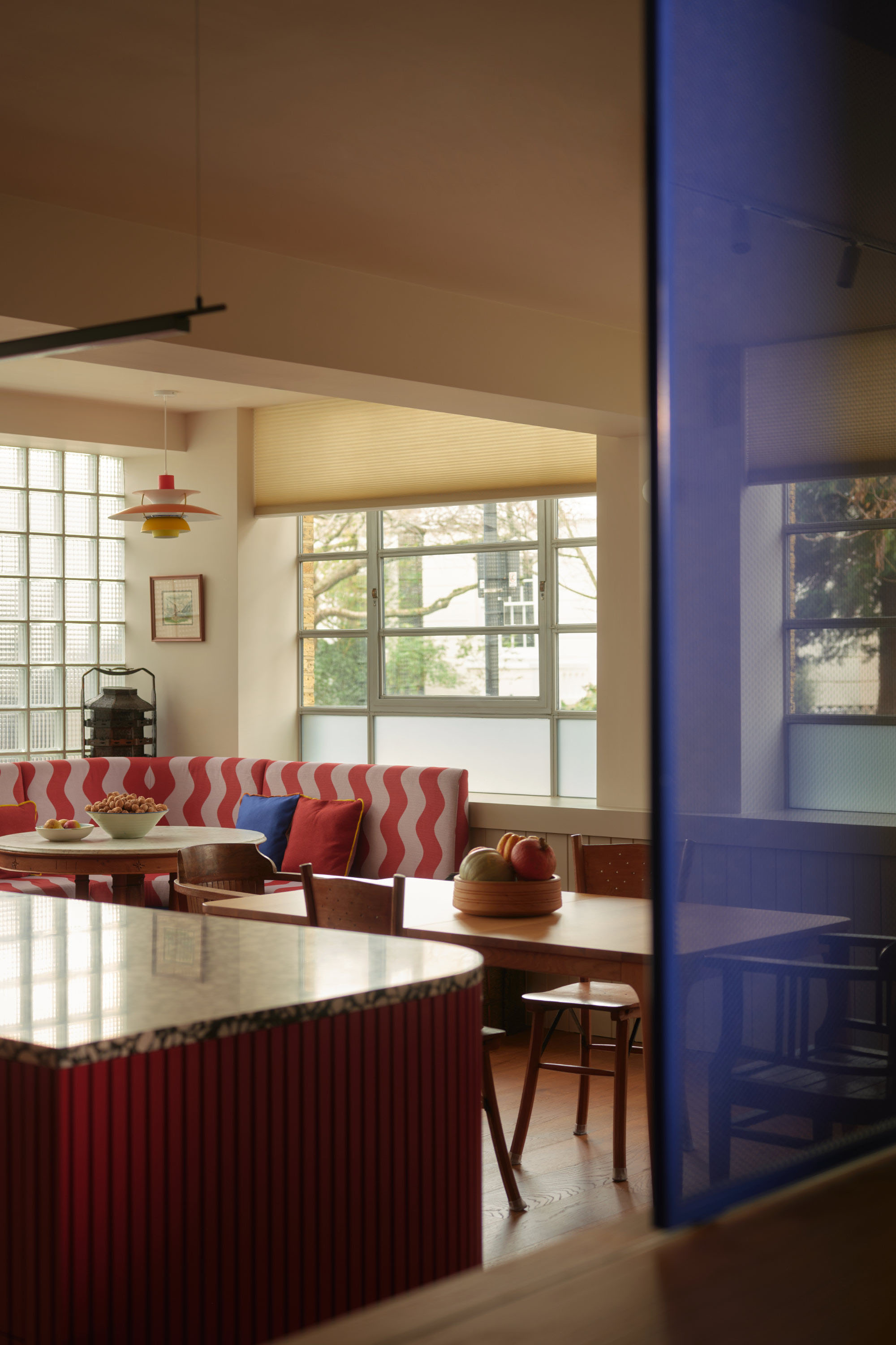 Open plan kitchen extension with large glazed windows, timber finishes and bright interior space.