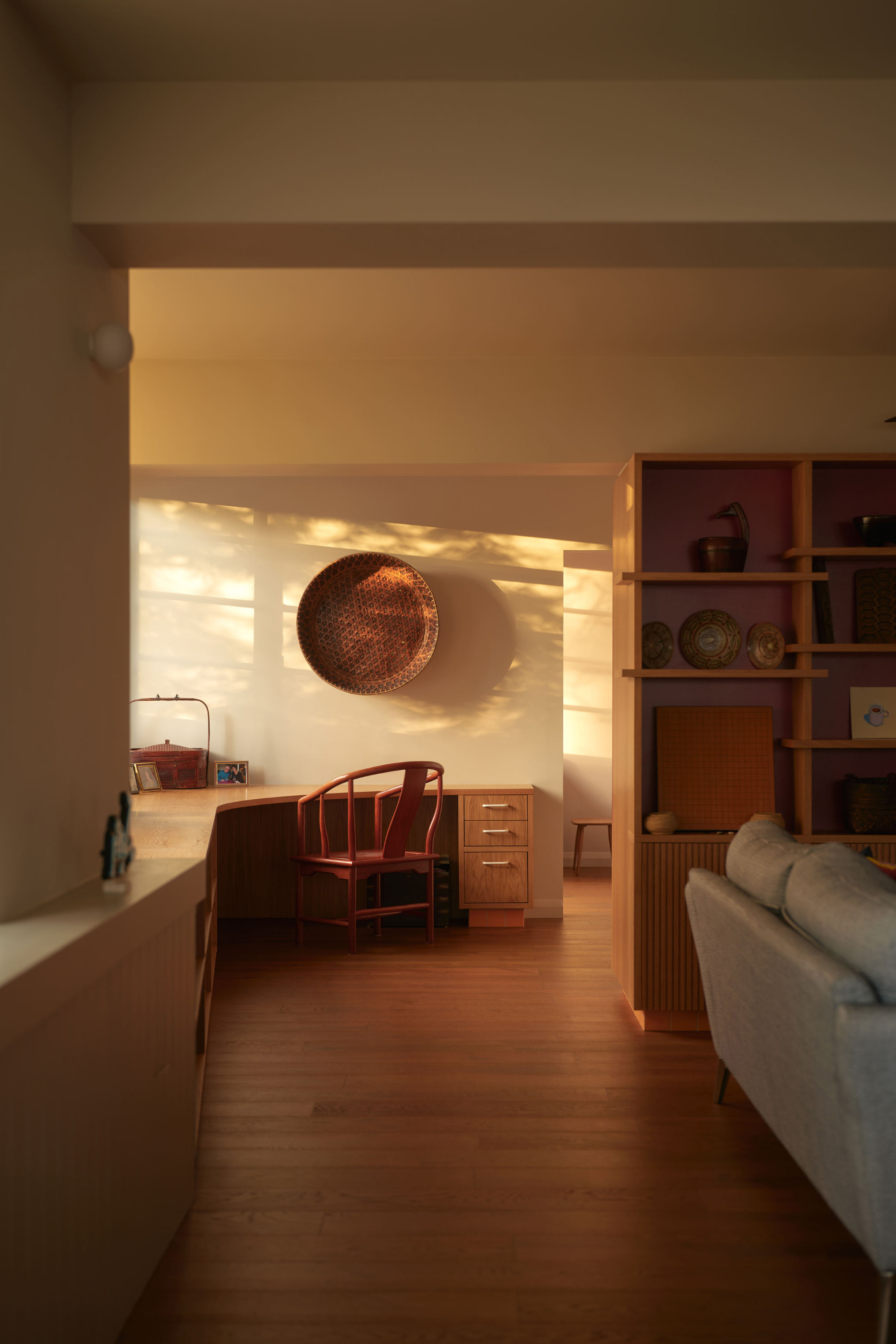 Open-plan loft conversion with timber flooring, natural light, and integrated workspace creating flexible living space.