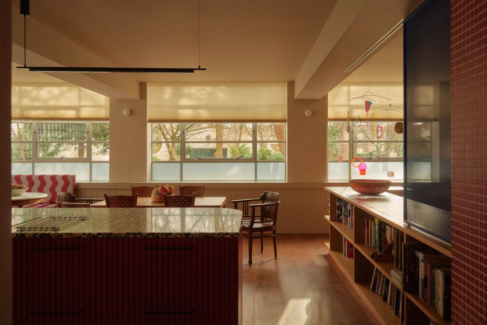 Open plan kitchen extension with brick and glazing, flooded with natural light through large windows.