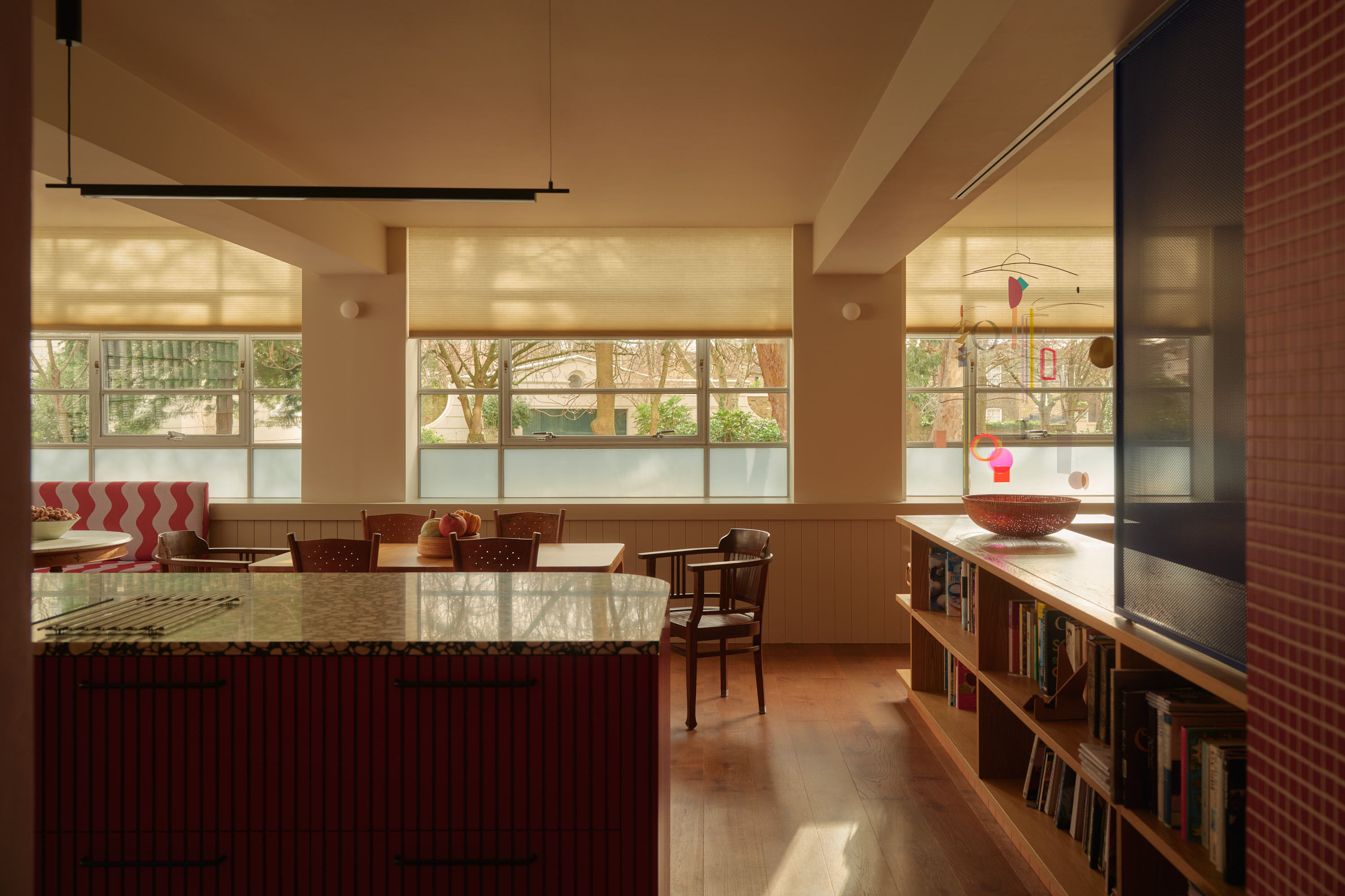Open plan kitchen extension with brick and glazing, flooded with natural light through large windows.
